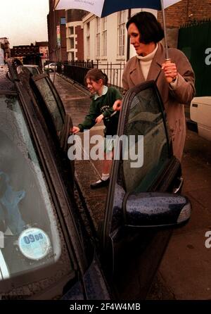 Being collected by car from The Cavendish school in Camden, Louisa O'Connell (9) with mum Irene O'Connell who collects her every day. Stock Photo