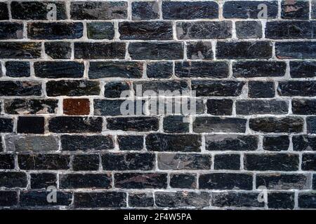 Background from a carbon black brick wall Stock Photo