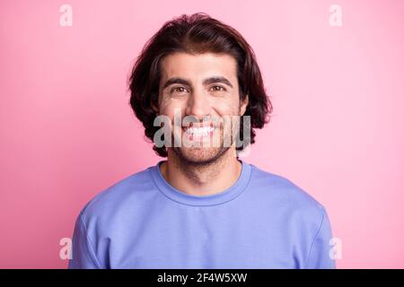Photo of happy positive young man wear purple pullover good mood smile isolated on pink color background Stock Photo