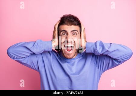 Photo of angry bristles brown haired man scream cover ears hands quarrel enough isolated on pastel pink color background Stock Photo