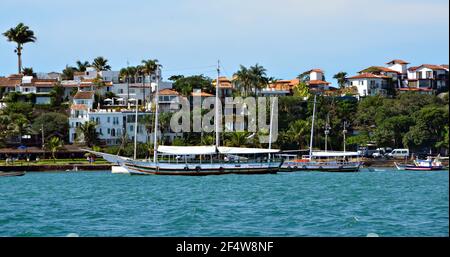 Landscape with view of a traditional sightseeing Schooner on the waters of Armação dos Búzios, the renown resort town of Rio de Janeiro, Brazil. Stock Photo