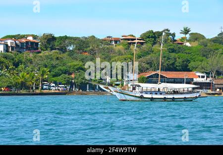 Landscape with view of a traditional sightseeing Schooner on the waters of Armação dos Búzios, the renown resort town of Rio de Janeiro, Brazil. Stock Photo