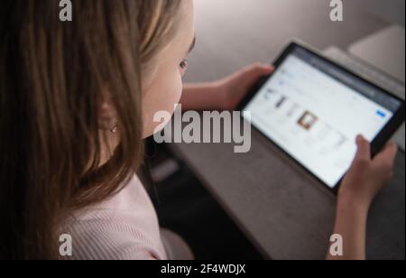 Caucasian Girl with Tablet Device in Her Hands. Wireless Modern Technologies. Internet Industry Theme. Stock Photo