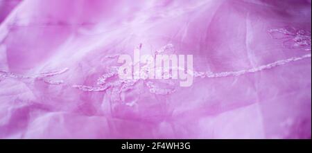 Pink background from silk organza with floral embroidery. Stock Photo