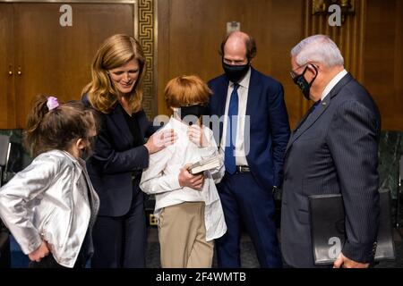 Washington, USA. 23rd Mar, 2021. Former US Ambassador to the United Nations Samantha Power (C-L) chats with Democratic Senator from New Jersey Robert Menendez (R), while her daughter Rian Power Sunstein (L), son Declan Power Sunstein (C), and husband Cass Sunstein (C-R) look on after she testified before the Senate Foreign Relations Committee to be the next Administrator of the United States Agency for International Development (USAID) in the Dirksen Senate Office Building in Washington DC, USA, March 23, 2021. (Photo by Pool/Sipa USA) Credit: Sipa USA/Alamy Live News Stock Photo