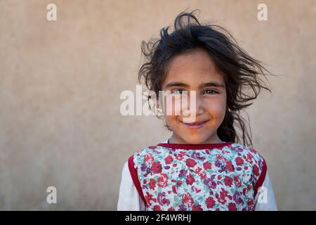 Erg Chebbi, Morocco - April 12, 2016: Two young girls in front of their home in a village near the Erg Chebbi, in Morocco. Stock Photo