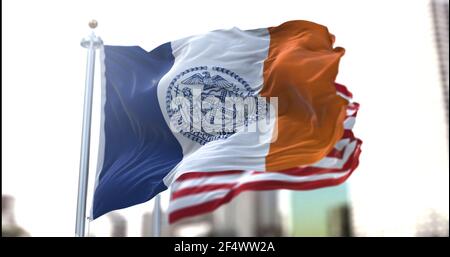 the official flag of New York City flapping along with the American Stars and Stripes national flag in the background. Official seal of New York City. Stock Photo