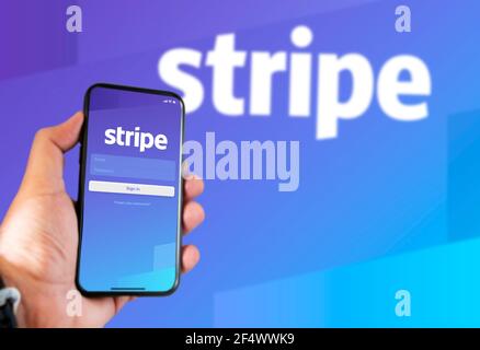 San Francisco, CA, USA, March 15, 2021: Stripe's application login page on the screen of a hand held smartphone. Background with blurry Stripe logo. S Stock Photo
