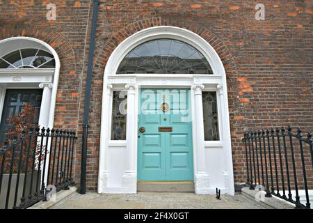 Georgian style old brick building facade with a turquoise arched  entrance door on Merrion Square Dublin, Ireland. Stock Photo