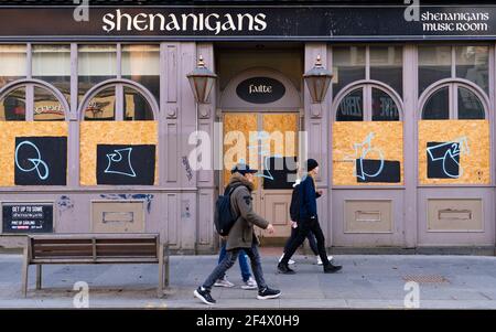 Glasgow, Scotland, UK. 23 March 2021. On the first anniversary of the coronavirus pandemic lockdown the streets in Glasgow city centre are still quiet with only essential shops open. Pic; Closed and boarded up bar on Sauchiehall Street.  Iain Masterton/Alamy Live News Stock Photo