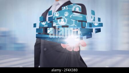 Composition of network of digital people icons over hand of businessman Stock Photo