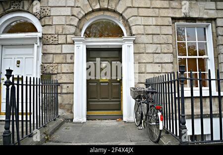 Georgian style stone building facade with an arched entrance door and side iron railing on Merrion Square Dublin, Ireland. Stock Photo