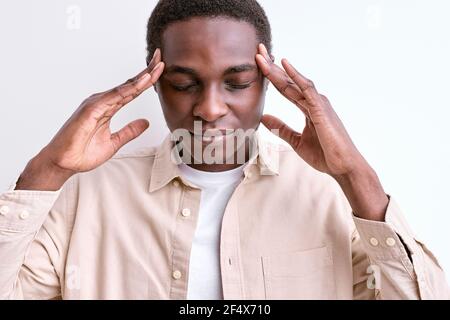 let's me think. confident black african man touching temples, stand having deep thoughts with eyes closed, concentrated on mind. isolated white studio Stock Photo