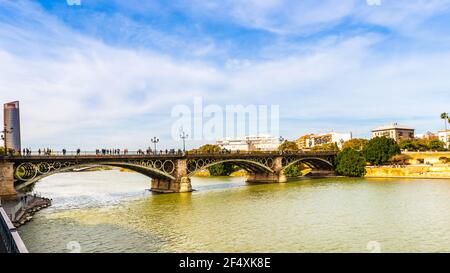 The Isabel II Bridge on the Guadalquivir River in Seville, Andalusia, Spain Stock Photo