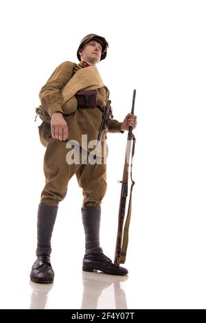 Male actor in the form of ordinary soldiers of the Russian army in the period 1939-1940, with the Tokarev Self-loading rifle on a white background in Stock Photo