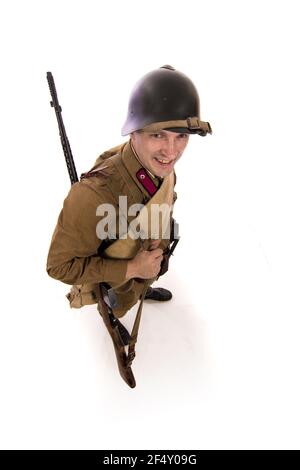 Male actor in the form of ordinary soldiers of the Russian army in the period 1939-1940, with the Tokarev Self-loading rifle on a white background in Stock Photo