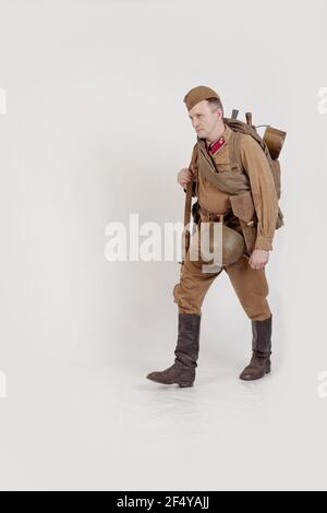 Male actor in the form of ordinary soldiers of the Russian army in the period 1939-1940, with aSelf-loading rifle Tokarev on a white background in the Stock Photo