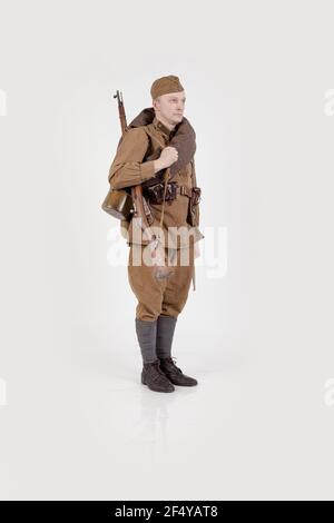 Male actor in the form of ordinary soldiers of the Russian army in the period 1939-1940, with aSelf-loading rifle Tokarev on a white background in the Stock Photo