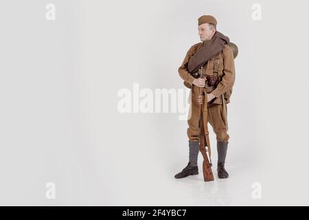 Male actor in the form of ordinary soldiers of the Russian army in the period 1939-1940, with aSelf-loading rifle Tokarev on a white background in the Stock Photo