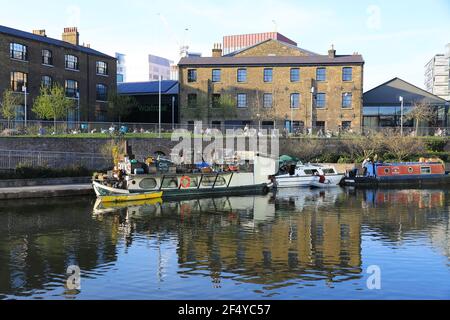 Historic buildings reflected in Regents Canal, by Granary Square, Kings Cross, north London, UK Stock Photo