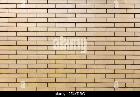 Brickwall background texture. Brickwork with row of beige color bricks, horizontal geometric design, building wall facade, masonry, stonewall backdrop Stock Photo