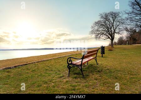 sunset over lake Balaton from Balatonakarattya high lakeside raised shore with a bench . Stock Photo