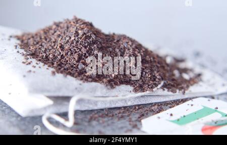 Branded Loose PG tip tea on a PG tea bag upclose isolated on a grey surface Stock Photo