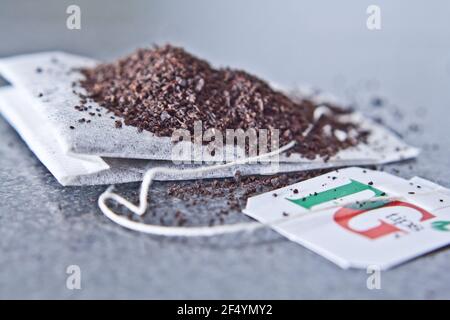 Branded Loose PG tip tea on a PG tea bag upclose isolated on a grey surface Stock Photo