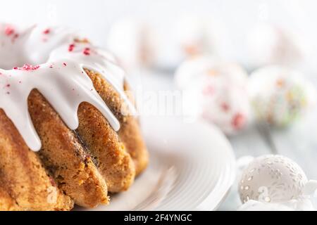 Festive easter marble cake with icing sugar with hand-decorated eggs. Stock Photo