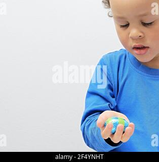 child with chocolate Easter eggs on white background stock photo Stock Photo