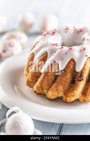 Festive easter marble cake with icing sugar with hand-decorated eggs. Stock Photo