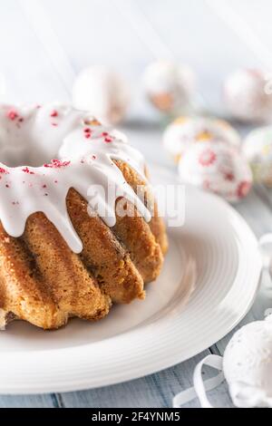 Festive easter marble cake with icing sugar with hand-decorated eggs. Stock Photo