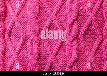 Hand knitted pink woolen sweater details background Stock Photo