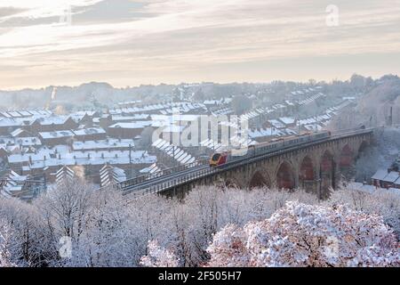 Winter view of a diesel passenger train crossing the railway viaduct at Durham in England, UK December 2005 Stock Photo