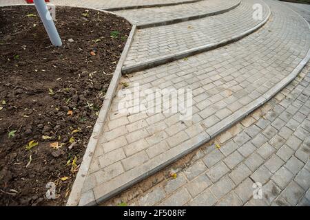 sagging paving stones. uneven pavement in the city square. sinking pavement of a pedestrian walkway Stock Photo