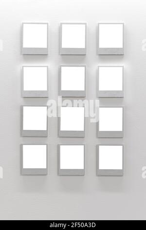 White wall with empty polaroid frames. Mock up Stock Photo