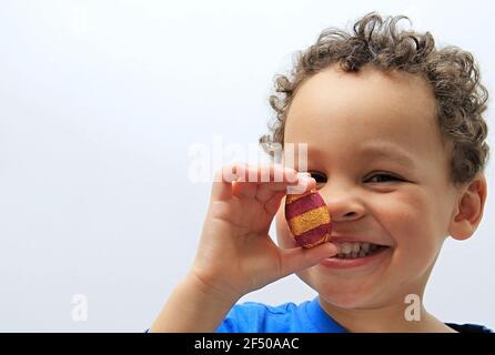 child with chocolate Easter eggs on white background stock photo Stock Photo