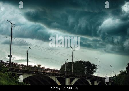 terrible clouds over the city. a sudden change in the weather. a heavy storm and thunderstorm is coming. gloomy dark clouds in the sky Stock Photo