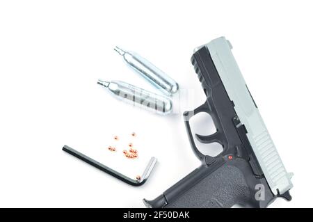 Air Gun, Co2 Cartridges, Pellets and Hex Key Isolated on White Background. Stock Photo