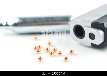 Air Gun, Co2 Cartridges and Pellets. Focus on a front pellets with shallow dof. Stock Photo