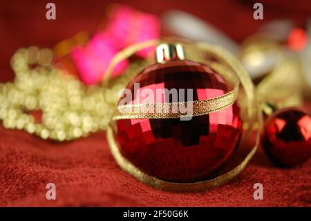 Christmas tree ball and golden ribbon on the background of Christmas ornaments Stock Photo