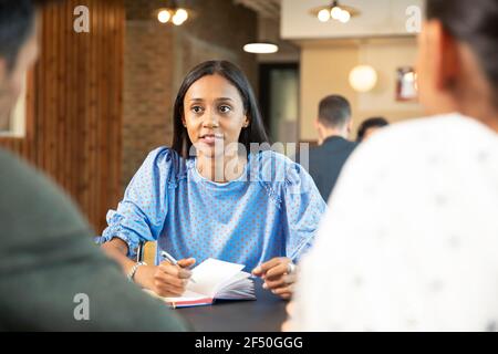 Business people meeting and taking notes in cafe Stock Photo