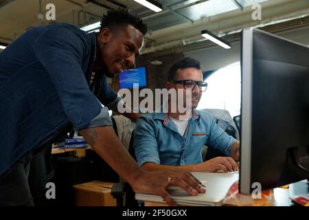 Businessmen working at computer in office Stock Photo