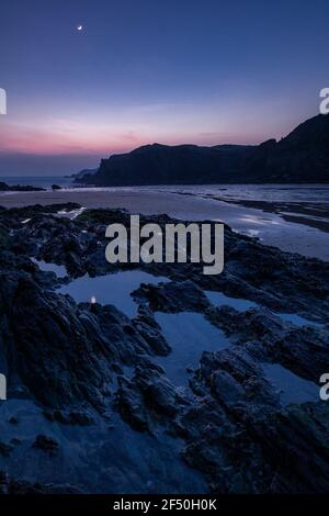 Trearddur Bay at low tide at dusk, Anglesey, North Wales Stock Photo