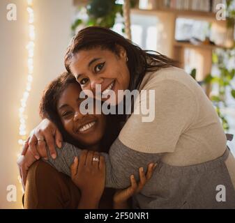 Portrait happy mother and daughter hugging Stock Photo