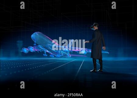 Man with VR headset watching holographic airplane takeoff Stock Photo