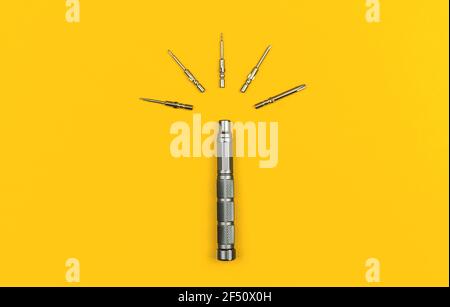 Screwdrivers set with bits on a yellow background, metal screwdriver kit photo Stock Photo