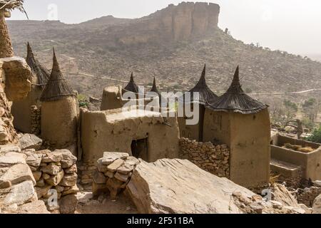 Thatched granaries in a partially abandoned Dogon village on the Bandiagara Escarpment in Mali Stock Photo