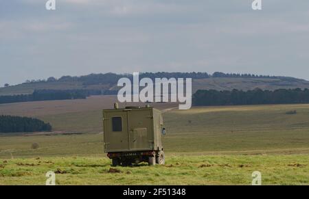 a British army Defender 130 Battle Field Ambulance in action on a military exercise, Wiltshire UK Stock Photo