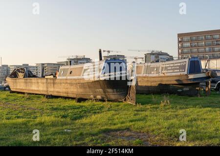 Two canal boats out of service, park in a dockyard ,grand union canal carrying co Ltd, London dockland Stock Photo